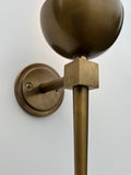 Angled close-up of a brushed brass wall sconce.