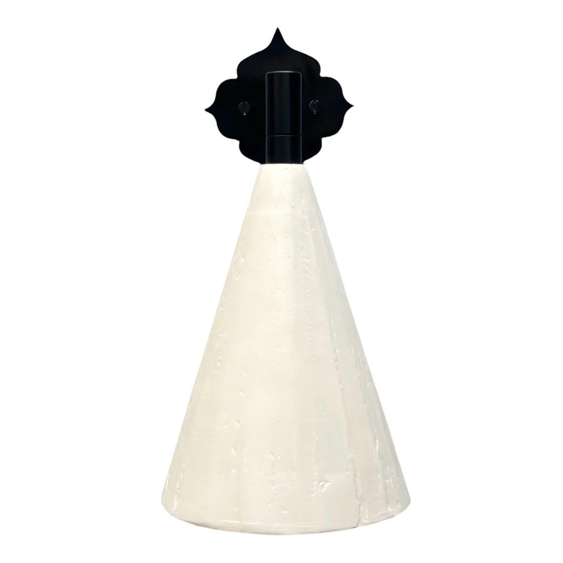 White conical wall sconce with an ornate black backplate.