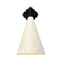 A wall-mounted sconce with a matte black, ornate, scroll-shaped backplate and a short, black arm, holding a downward-facing, textured off-white conical shade. A warm, yellow-orange light glows from the interior of the shade.