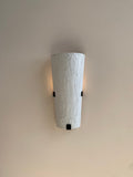 Textured white wall sconce with black accents.