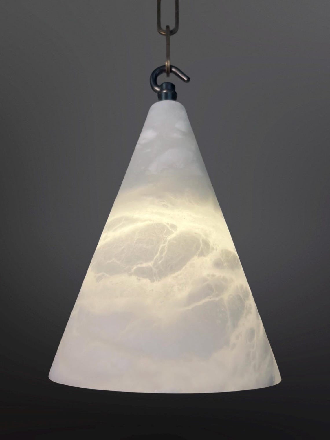 A conical white glass pendant light with swirling patterns, hanging from a chain.