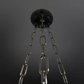 A close-up, low-angle view of a dark ceiling plate with three hanging chains.