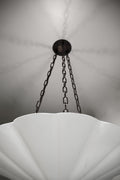 A white fluted pendant chandelier with dark chains.