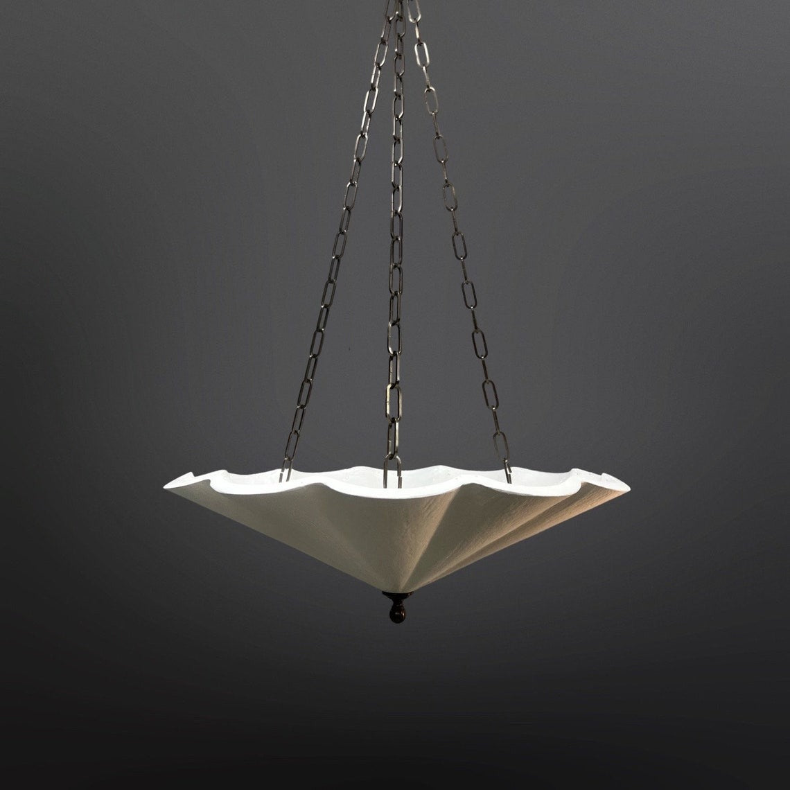 A white, fluted pendant light with a scalloped edge.