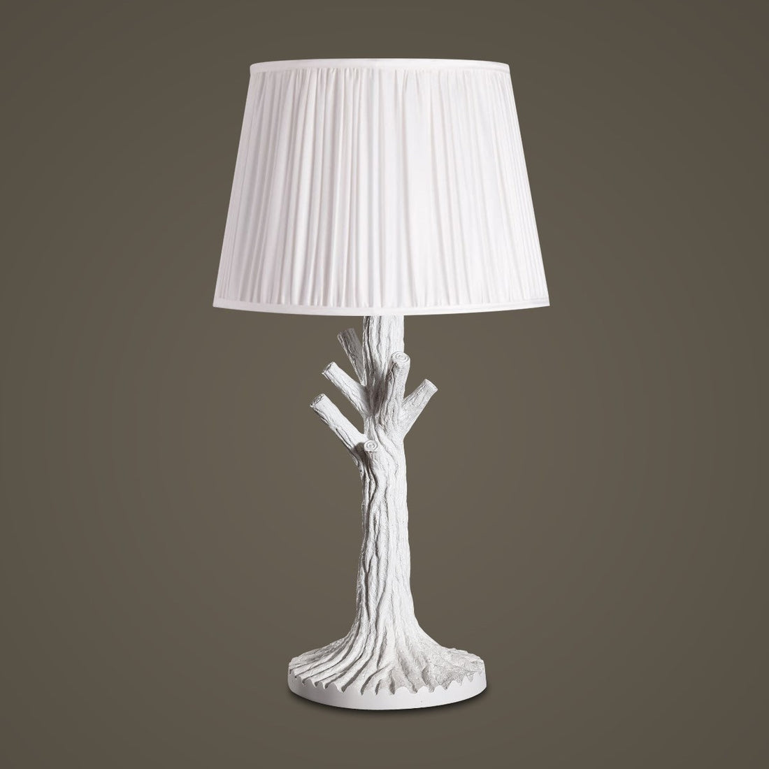 White tree-trunk table lamp with a pleated shade.