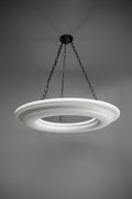 White circular pendant light with a textured surface, suspended by chains.